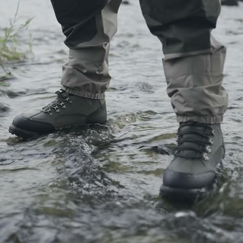 Person wearing hiking boots standing in a stream